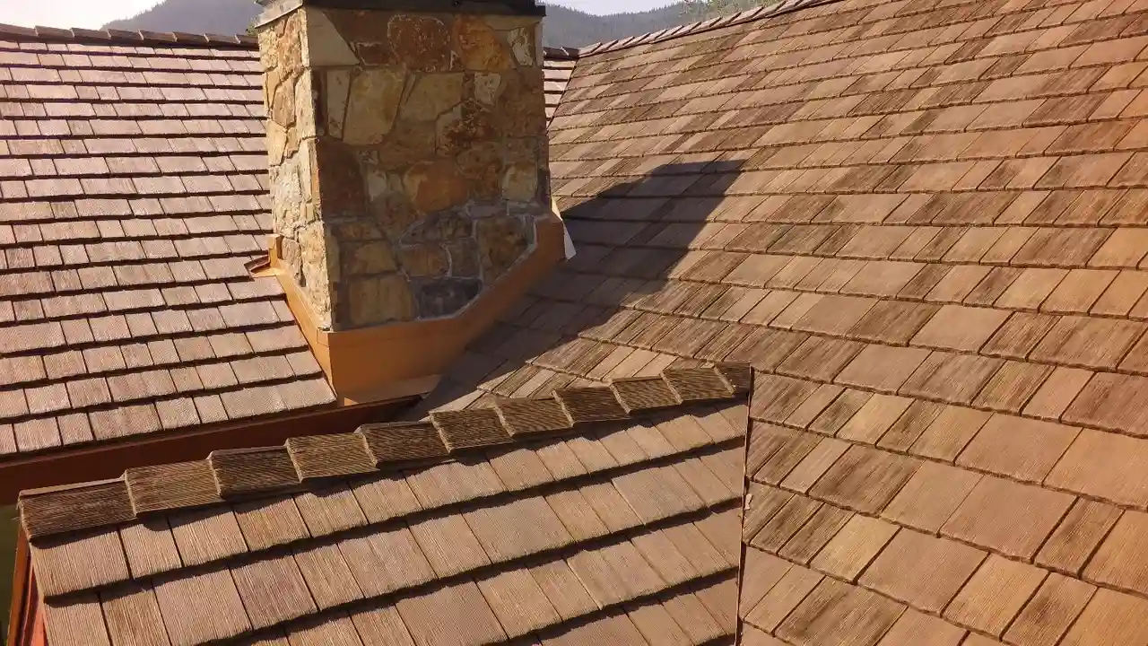 Close up on a plate of mashed potatoes, topped with baked pork chops with cream of mushroom soup, and a side of green beans.