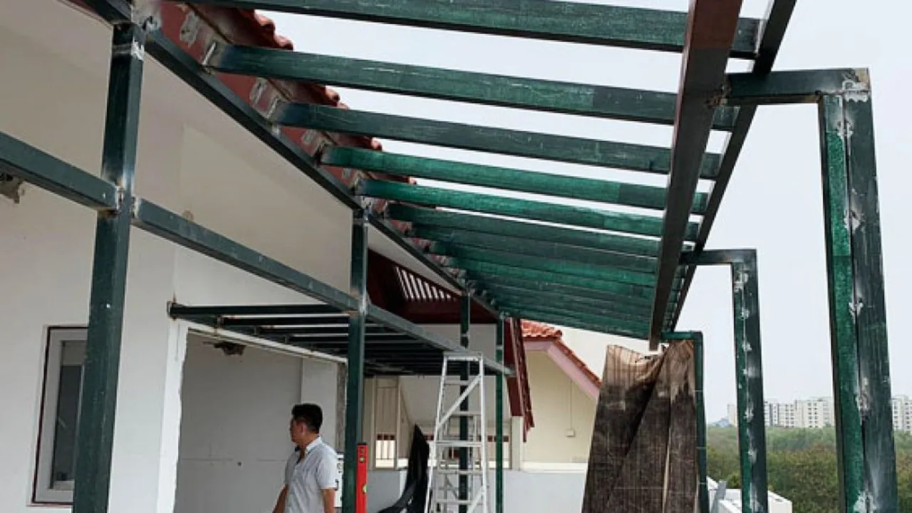 Close up on a plate of mashed potatoes, topped with baked pork chops with cream of mushroom soup, and a side of green beans.