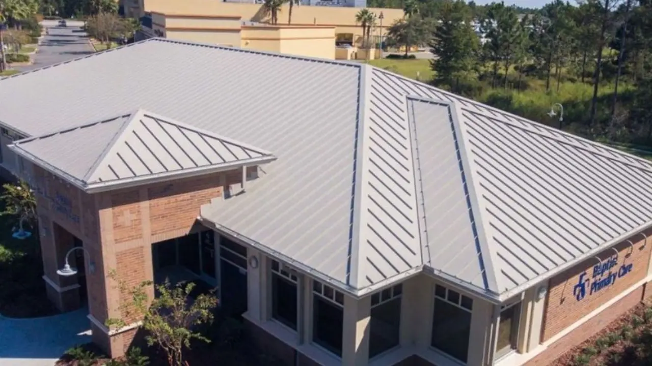 Close up on a plate of mashed potatoes, topped with baked pork chops with cream of mushroom soup, and a side of green beans.